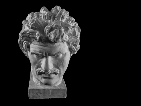 White plaster bust sculpture portrait of a young man with a mustache