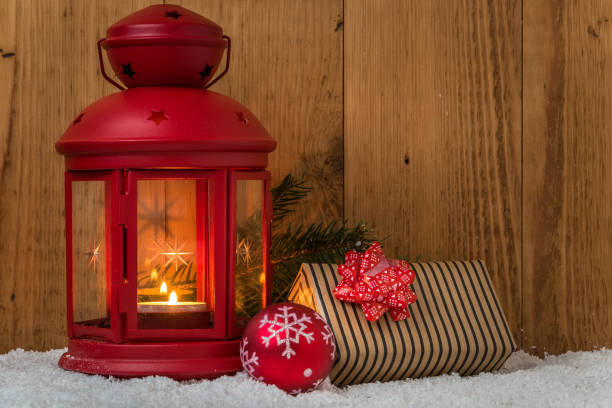 istock Chrismas Decorations Lit By a Red Lantern on Wooden Background 872632344