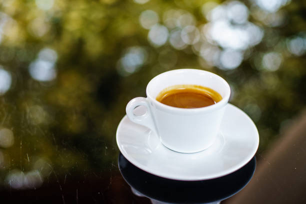 istock Espresso cup in glass background with bokeh 872639088
