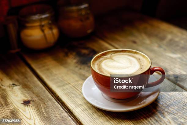 Cup Of Coffee Latte On Wooden Table Stock Photo - Download Image Now - Coffee Cup, Table, Cityscape