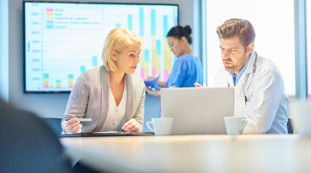 istock doctor working with medical sales professional 872639424