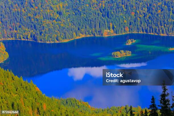 Aerial View Of Beautiful And Idyllic Eibsee Alpine Turquoise Lake With Reflection At Gold Colored Sunrise View From Above Zugspitze Mountain Peak Dramatic And Majestic Landscape In Bavarian Alps Gold Colored Autumn Garmisch Bavaria Germany Stock Photo - Download Image Now