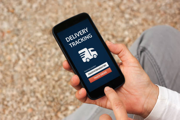 istock Hands holding smart phone with delivery tracking concept on screen 872662586