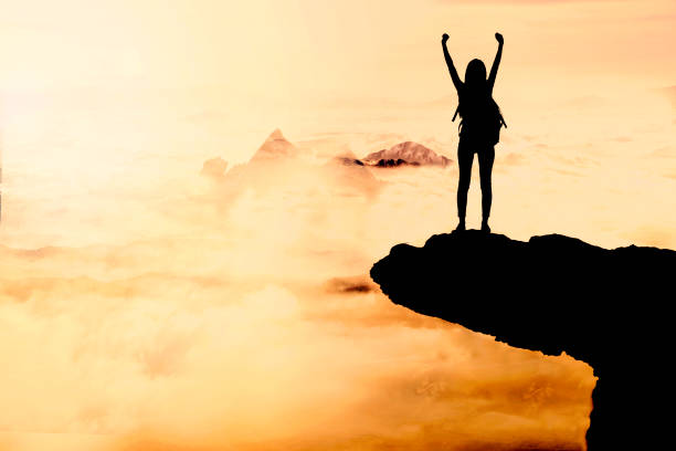 istock Woman Silhouette at sunset on hill 872663450