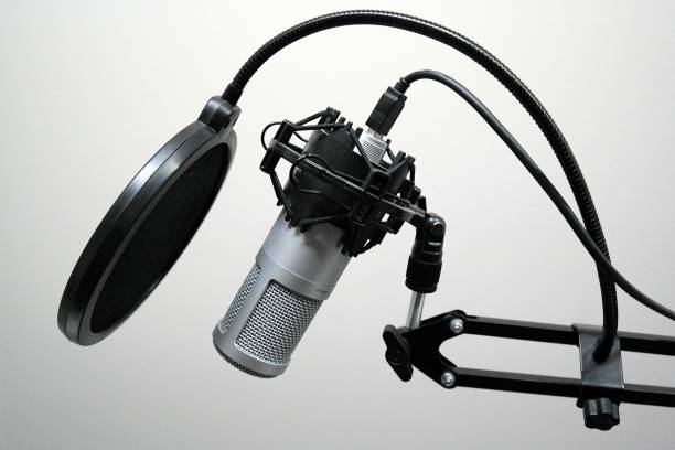 istock A microphone set up to record voice overs with wind screen and shock mount 872667070