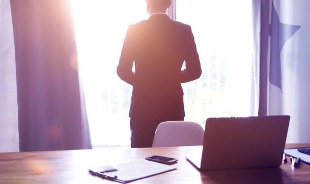 istock Rear angle view of businessman thinking the future vision at office . 872667588
