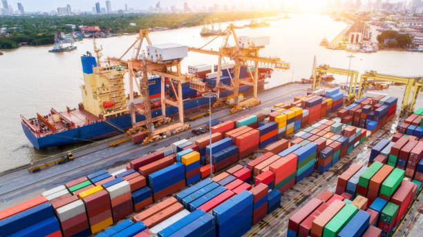 istock Logistics and transportation of Container Cargo ship and Cargo plane with working crane bridge in shipyard at sunset 872677258
