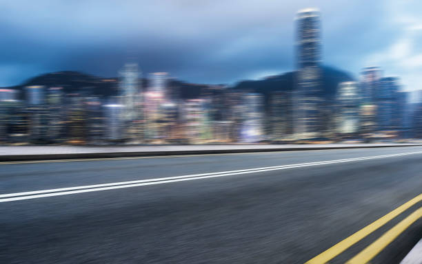 istock modern skyscrapers with empty highway against cloudy sky in Hong Kong 872683580