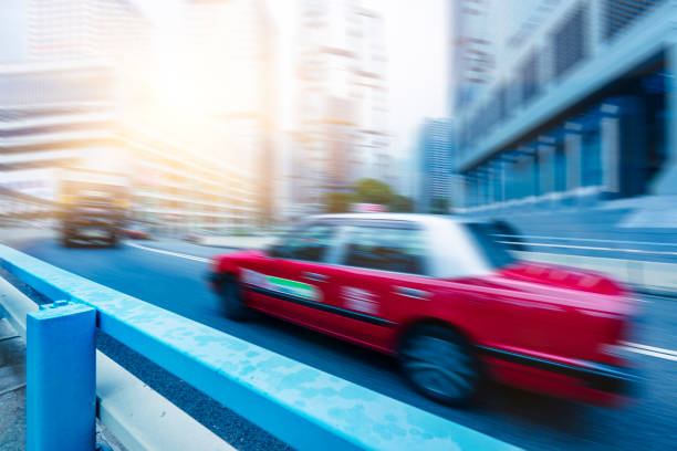 istock red cabs driving on Hong Kong road 872684260