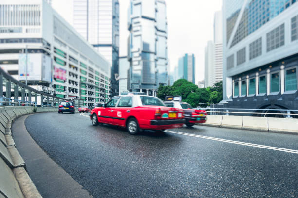 istock red cabs driving on Hong Kong road 872684274