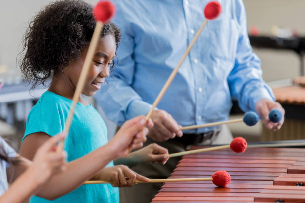istock Little girl concentrates during xylophone practice 872698002