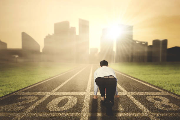 istock Businessman ready to run toward a city 872703706