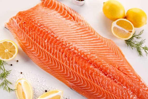 istock Fresh raw salmon fillet on white background 872704720
