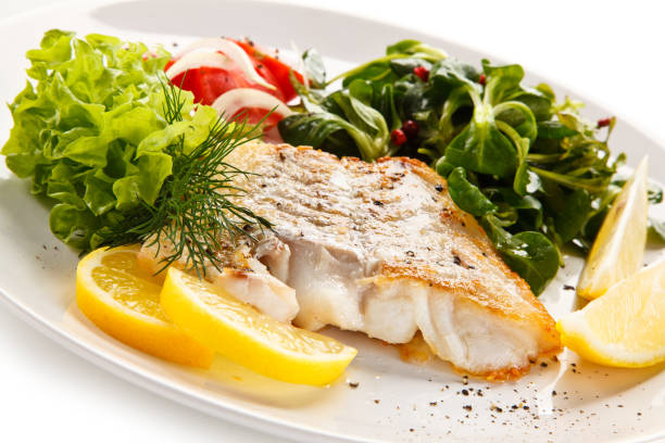 istock Fish dish - fried fish fillet and vegetables 872714196