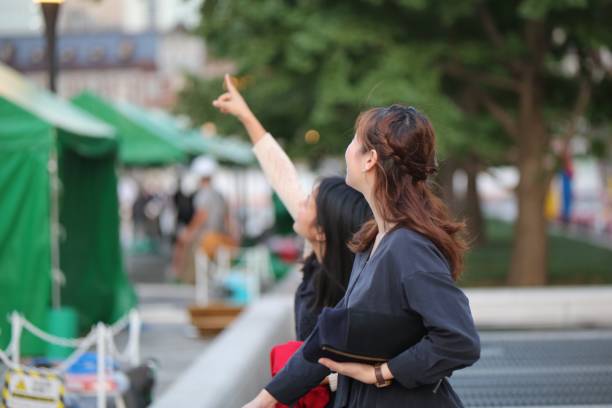 istock Young women ponting something in the sky 872714222