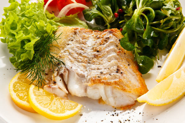 istock Fish dish - fried fish fillet and vegetables 872714634