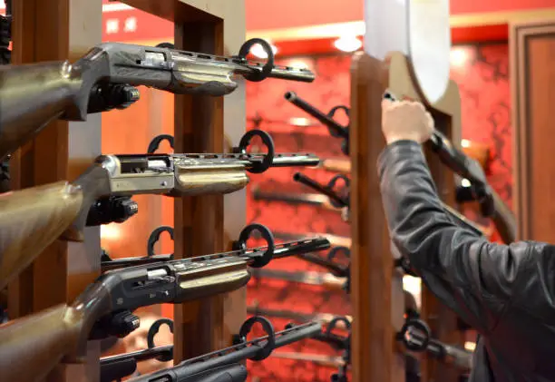 Submachine Gun on the wood wall close-up