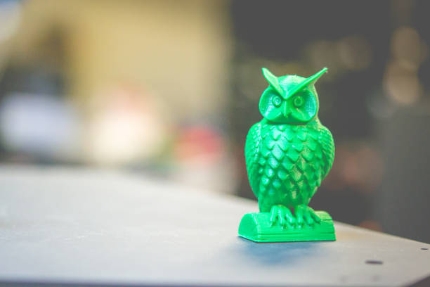 istock The green form in the form of a small owl created on 3d printer dark background 872720584
