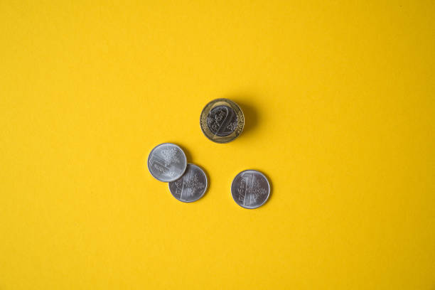 istock Coins close-up on a yellow background 872722306