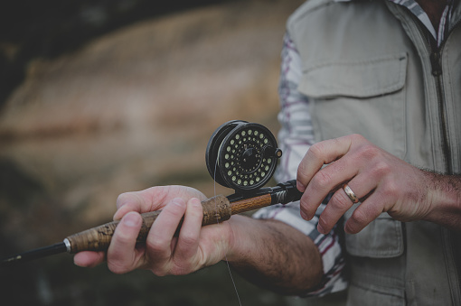 Fly-fisherman's hands attaching rod and reel Western Cape Cape Town South Africa