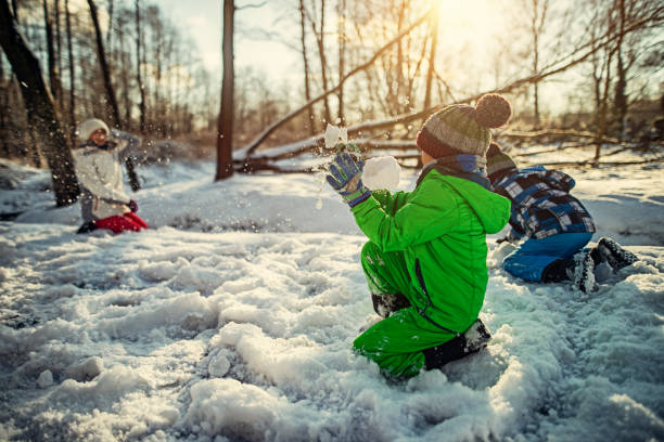 istock Kids having showball fight in winter forest 872729126