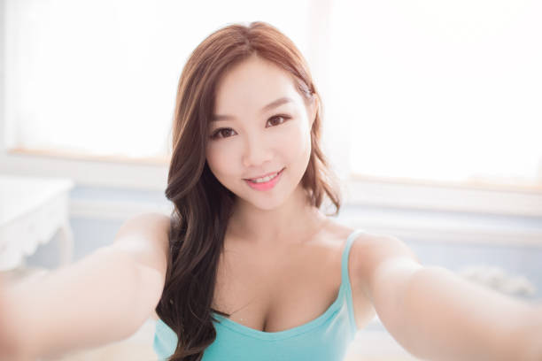 istock woman selfie in home 872731358