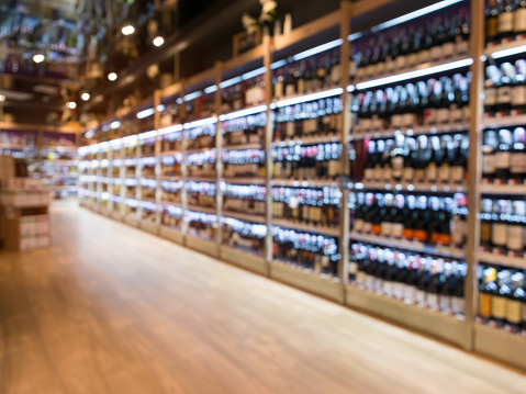 Blurred winery store department in supermarket for background.