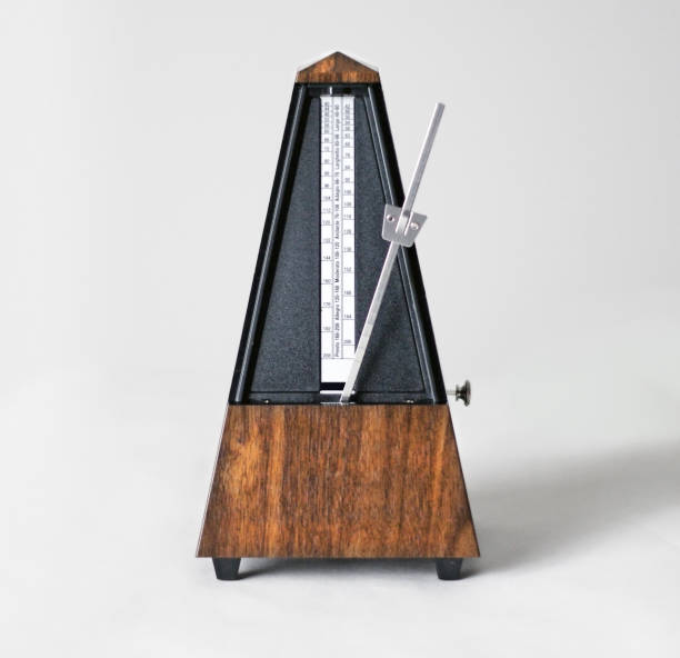 metronome in action, closeup, isolated and on a plain background - allegro imagens e fotografias de stock