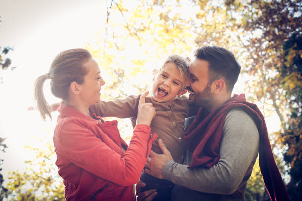 istock Mother and father have fun with daughter. 872732314