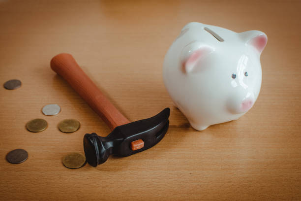 istock Little boy breaking a piggy bank 872735516