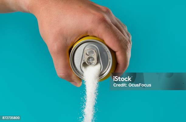 Man Hand Holding Lemon Refresh Drink Can Pouring Sugar Stream In Sweet And Calories Content Of Soda And Energy Drinks Stock Photo - Download Image Now