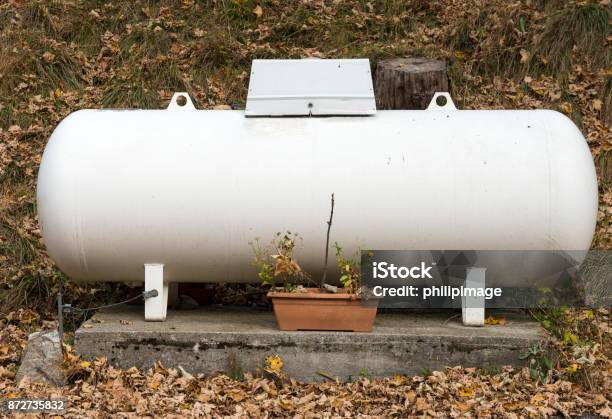 A Propane Gas Tank In A Garden Stock Photo - Download Image Now - Storage Tank, Heat - Temperature, Long Play Record