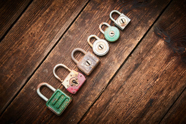 Group of old rusty padlocks on brown wooden grunge table