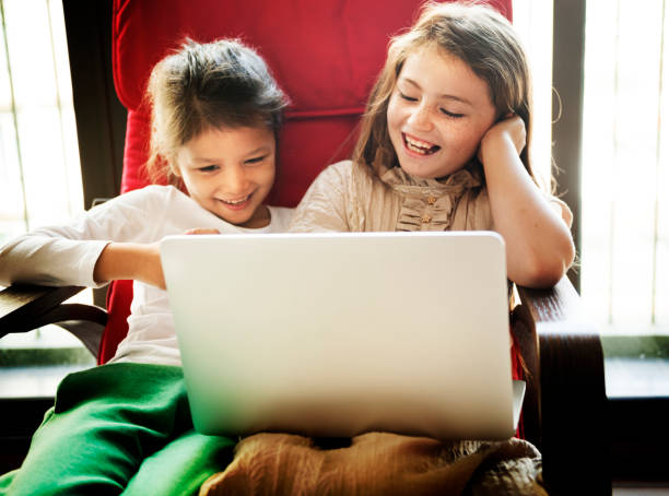 istock Little girls playing with a laptop 872746558