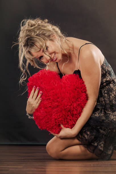 istock Mature woman hug big red heart 872746644