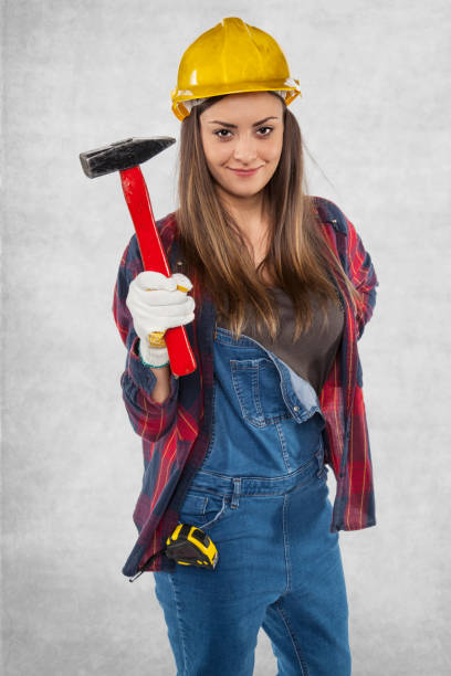 istock Female engineer with a hammer in her hand 872749324