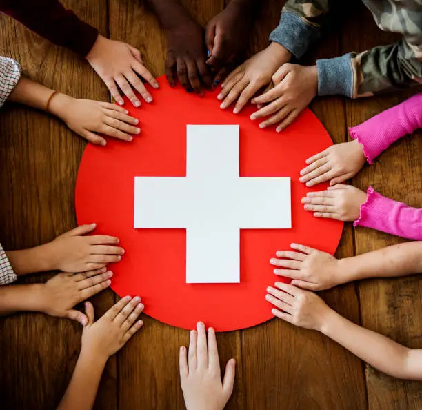 A group of young children learning about first aid