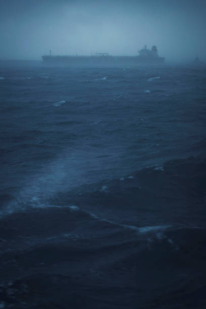 istock Shadow of a cargo boat sailing in a rough sea 872749554