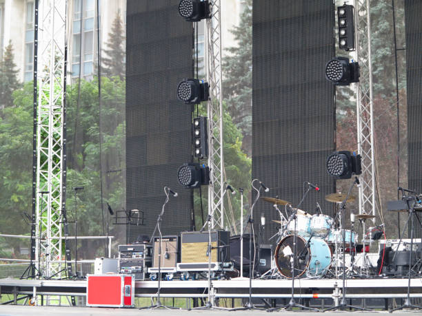 istock lighting equipment, drums, electronics and sound amplifiers on concert stage 872753232