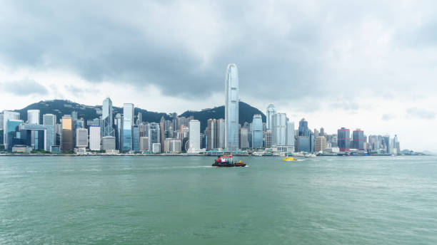 istock Hong Kong skyline against cloudy sky 872756648