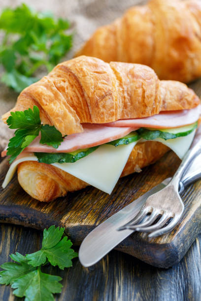 istock Delicious croissant with ham and cheese. 872761144