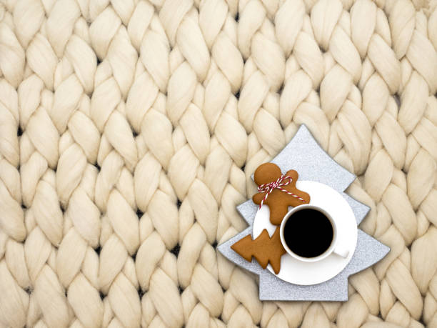 istock Cozy composition, closeup merino wool blanket, warm and comfortable atmosphere. Knit background. Cup of coffee and ginger cookies. Christmas concept. 872762162