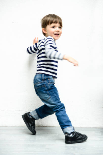 istock little kid portrait against a white wall 872764398