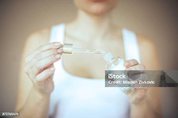 Close Up Of Woman Hands With Makeup Applying Serum Treatment Stock Photo - Download Image Now