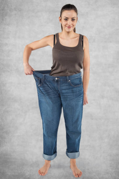 istock Girl in old pants, lost weight 872765604