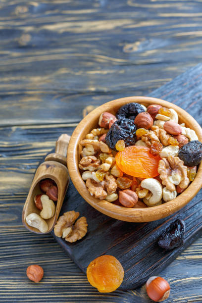 istock Nuts and dried fruit in a wooden bowl. 872769074