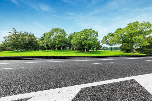 istock Asphalt road and green forest nature landscape 872769170