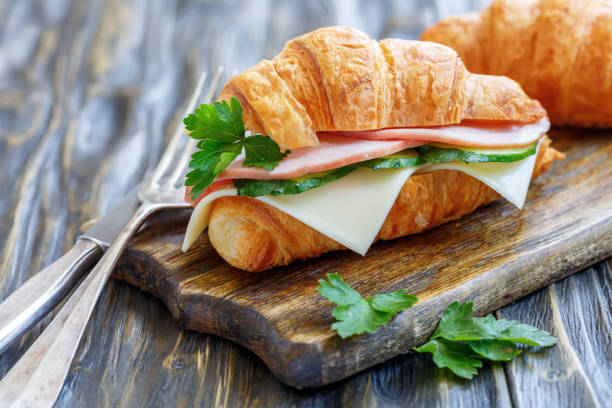 istock Croissant with ham, cheese and parsley. 872769384