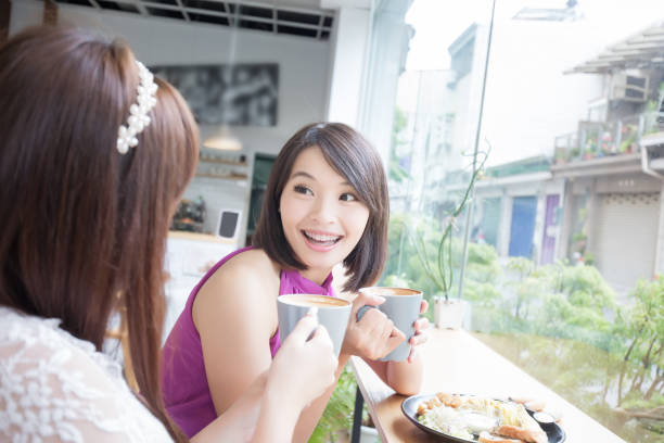 istock happy woman friends in restaurant 872769558
