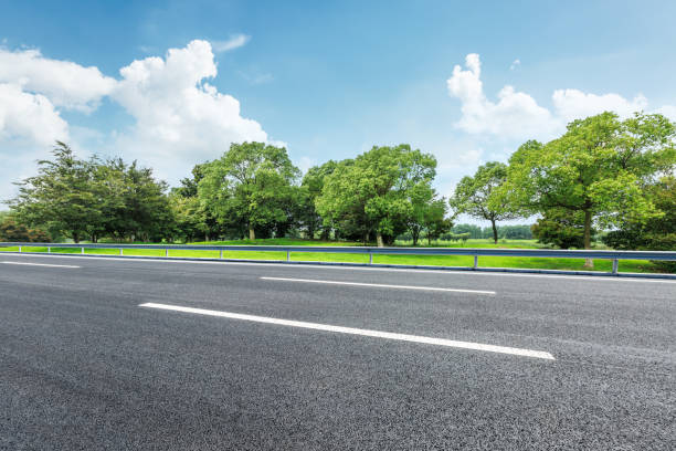istock Asphalt road and green forest nature landscape 872769764
